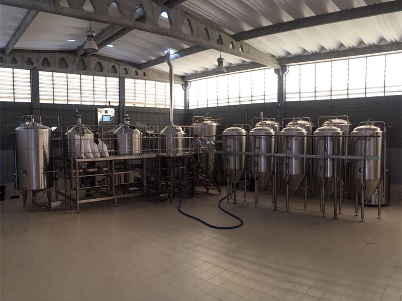 Área de produção de cervejaria com tanques de inox